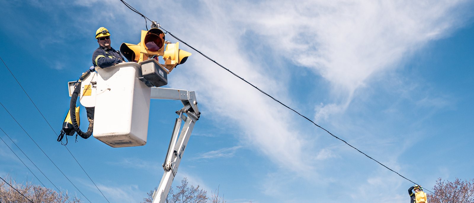 A traffic-signal crew at work in a bucket truck on a Bathurst street